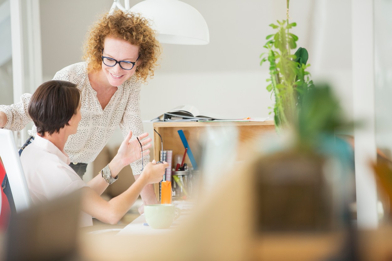 Women talking and smiling in office